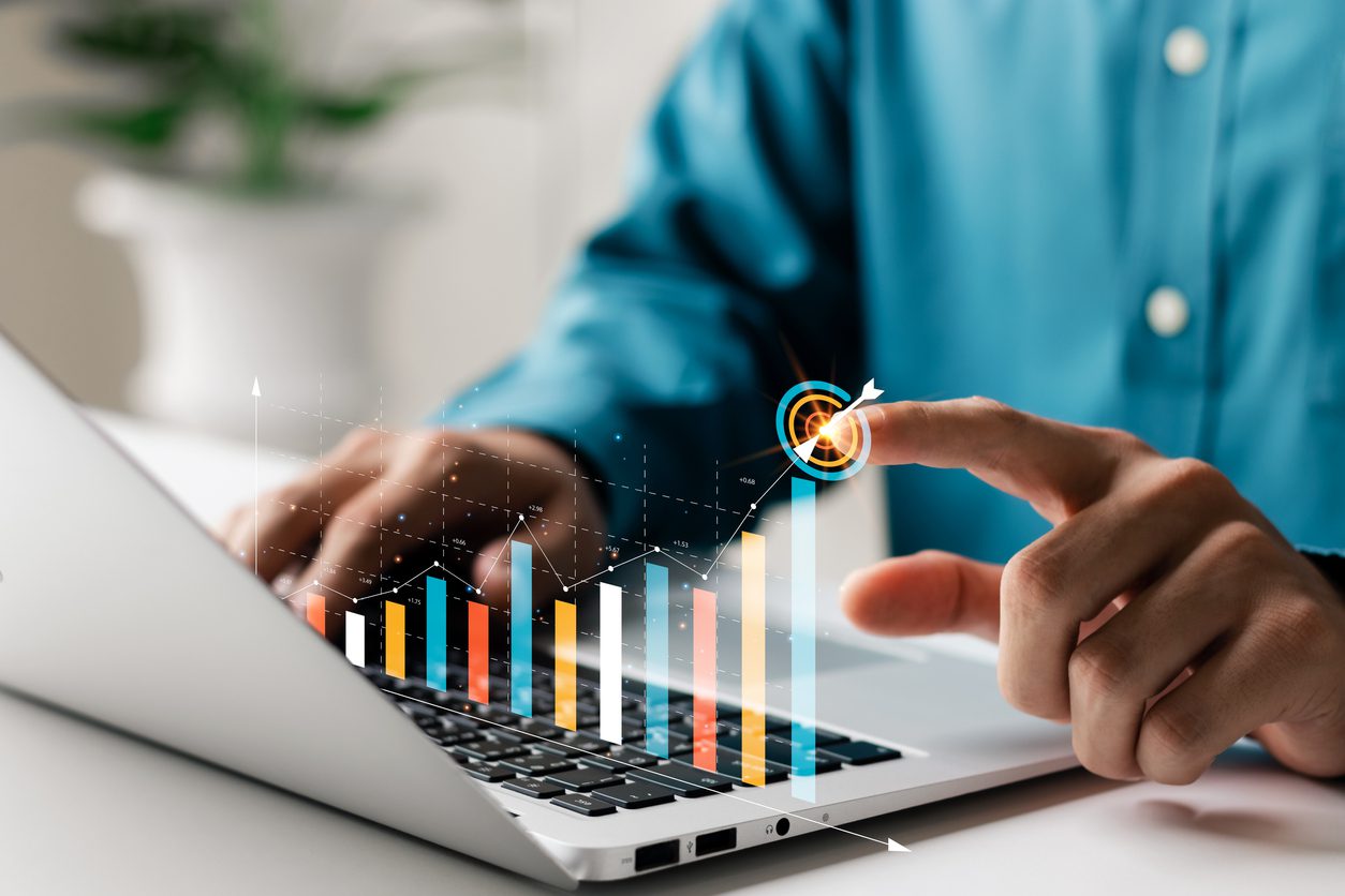 Businessman analyzing company’s financial balance sheet working with digital augmented reality graphics. Businessman calculates financial data for long-term investment.